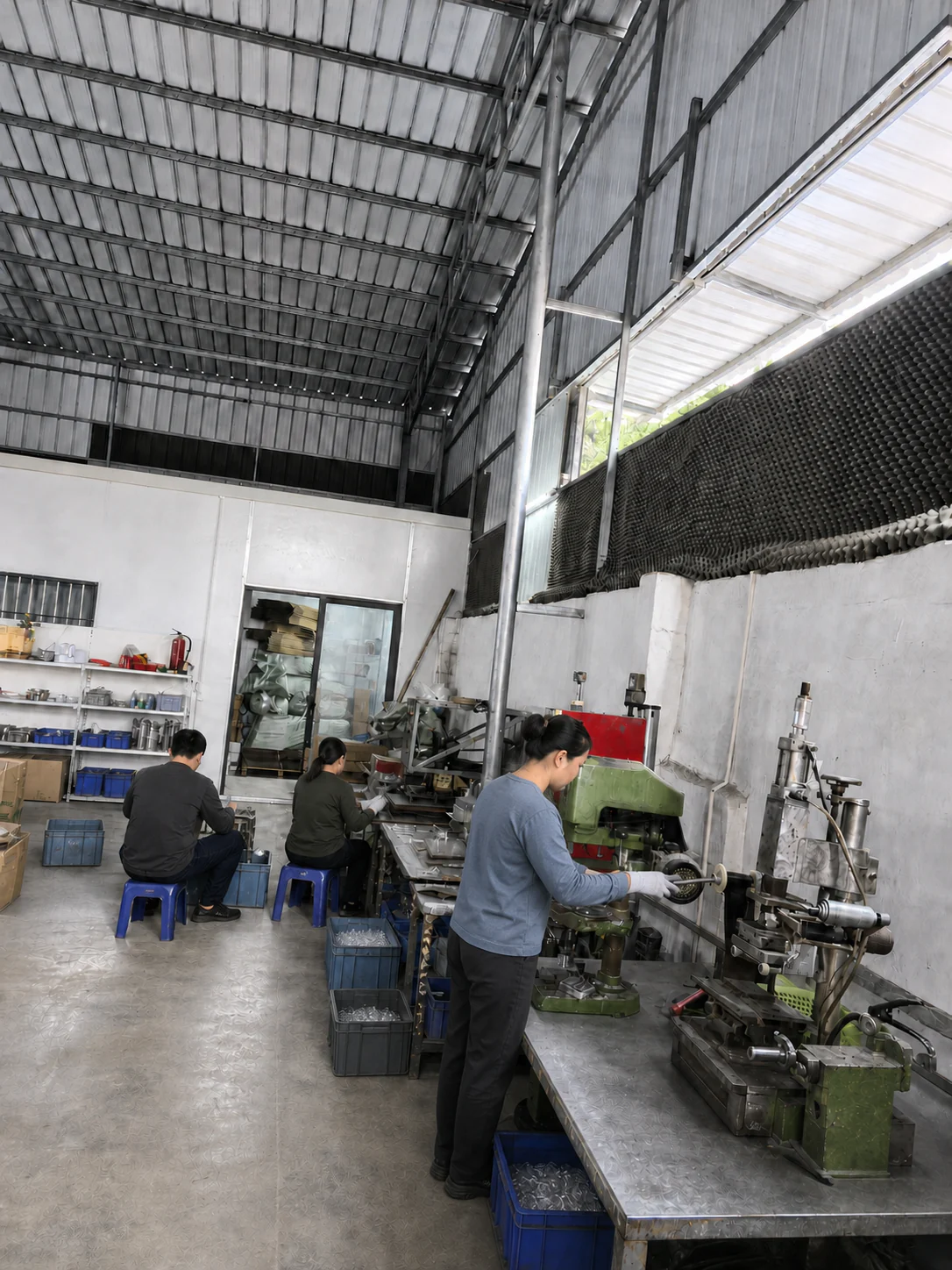 Workers operating equipment in the GLORWIN production workshop